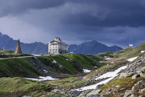 The Petit-Saint-Bernard hospice and statue of Saint Bernard de Menthon at the Little St Bernard Pass in the French Italian Alps