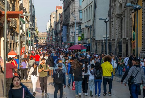 Crowd of people on pedestrianised street Avenida Madero