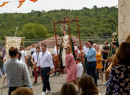 Village fiesta procession of villagers with statue of Virgin Mary