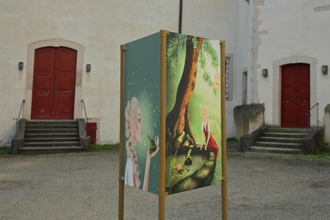 Poster for the fairy tale Frog Prince in the courtyard of the Deutschordenschloss