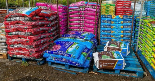 Bags of bark and compost on sale in garden centre