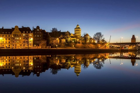 Gothic Burgtor Gate reflected in water of the Elbe Luebeck Canal