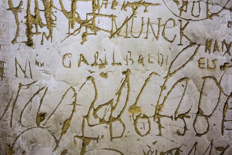 Old graffiti and scratchwork on wall inside the medieval Chateau de Bouillon Castle