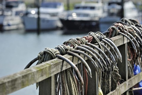 Row of anchors hanging from jetty in the harbour of Yerseke along the Oosterschelde