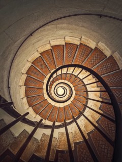 Circular staircase with black metal railing