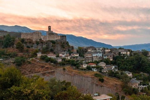 Sunset over the clock tower and fortress of Gjirokaster