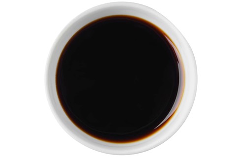 Top view of bowl with oyster sauce isolated on white background