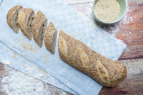 Freshly baked vegan baguette with sesame seeds