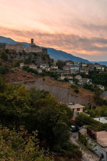 Sunset over the clock tower and fortress of Gjirokaster