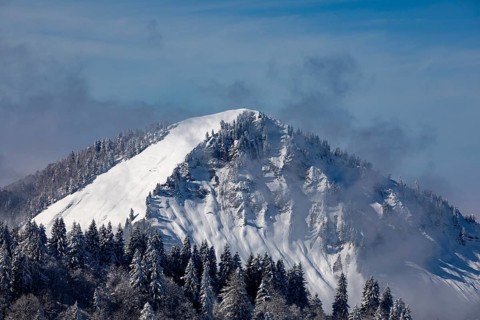 Deeply snow-covered winter landscape with a view of the Faistenau Schafberg