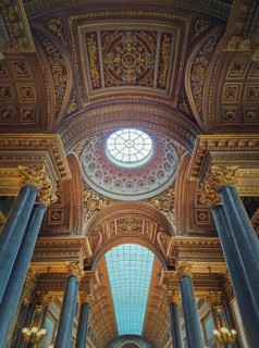 Architectural details with the glass ceiling and golden ornaments inside the Versailles palace hall