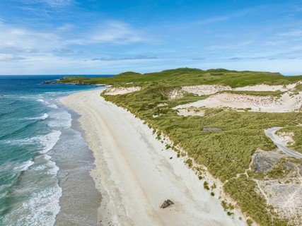 Aerial view of Faraid Head peninsula with dunes and sandy beach