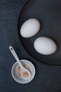 Two eggs and shell with natural salt