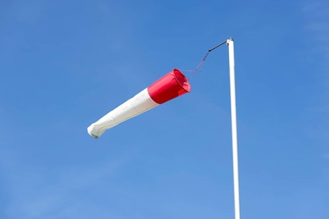 White-red windsock against blue sky