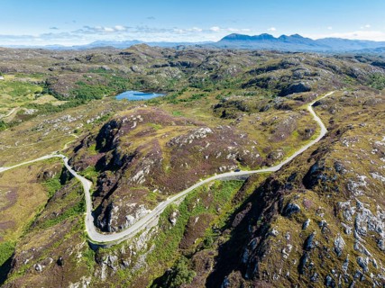 Aerial view of the sparsely populated Northwest Highlands with the single track road and pass road B869