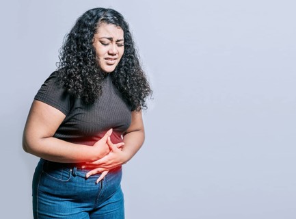 Woman with abdominal pain isolated. Young woman suffering stomach pain. Person with stomach pain isolated