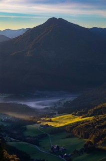 Farms at sunrise and morning fog near Ebenau