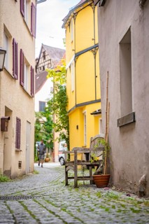 Narrow alleyway alley with wooden bench
