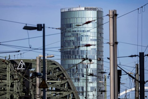 The Koelntriangle office tower with arches of the Hohenzollern Bridge and railway overhead line