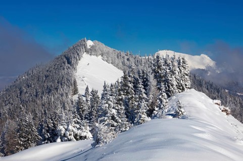 Winter landscape covered in deep snow in the Osterhorn group with a view from Pillstein to Zwoelferhorn