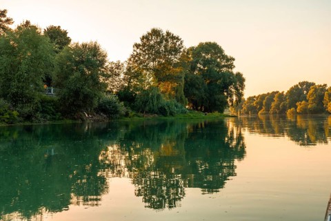 Sunset from a boat on a tourist excursion on Lake Shkoder in Shiroka. Albania