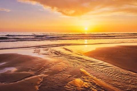 Atlantic ocean sunset with surging waves at Fonte da Telha beach