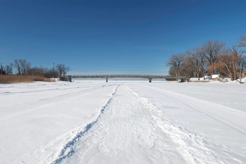 Vehicle tracks on snow covered frozen river