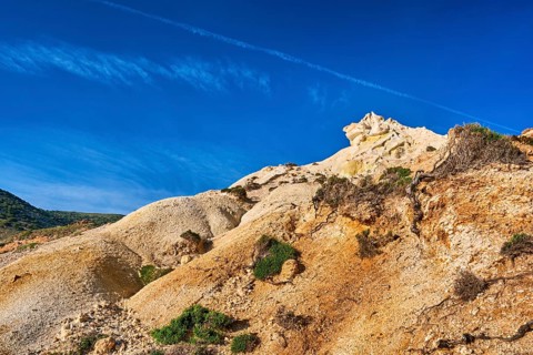 Unique natural rock formations of yellow and orange cliffs in low sunlight