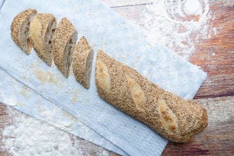 Freshly baked vegan baguette with sesame seeds