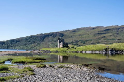 The ruins of Ardvreck Castle on a peninsula in the freshwater loch of Loch Assynt