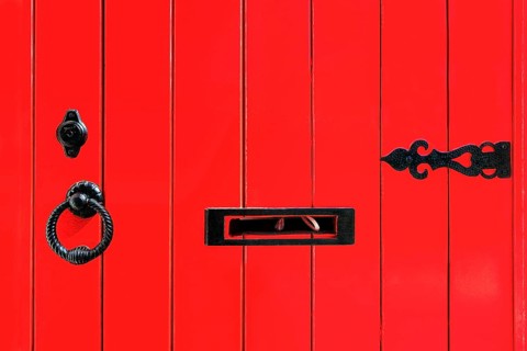 Red wooden door with fittings