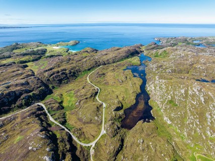 Aerial view of the sparsely populated Northwest Highlands with the single track road and pass road B869
