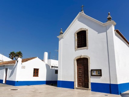 Church painted blue and white in village square