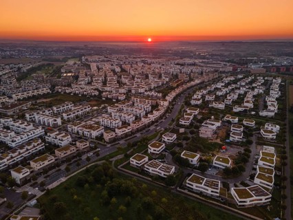 The sun rises behind the Riedberg district of Frankfurt.