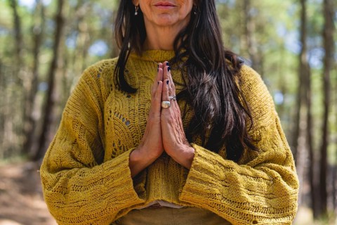 Close up of woman's clasping hands outdoors