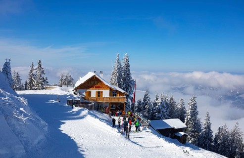 Winter landscape with ski tourers and alpine hut at Zwoelferhorn