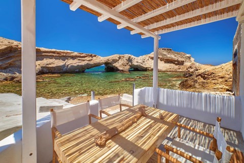 Summer villa by seafront on sunny day. Small private bay