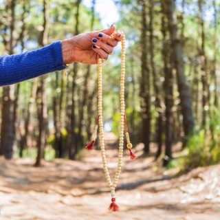 Close up of a japa mala over nature bakcground