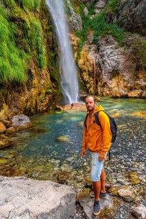 Hiker at Grunas waterfall in Theth national park