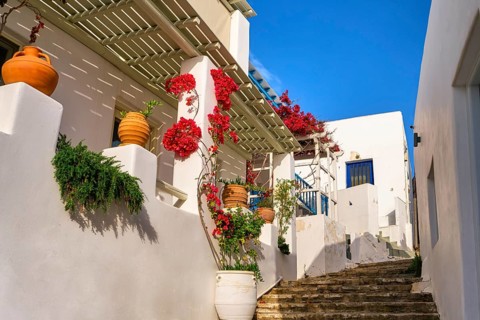 Traditional Greek island town alleyway with whitewashed walls