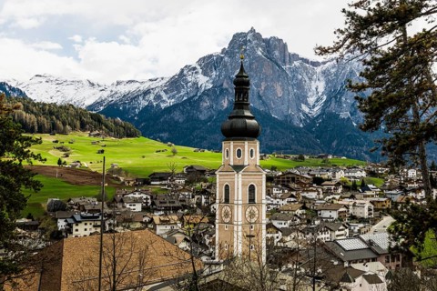 Village and snow-capped mountains