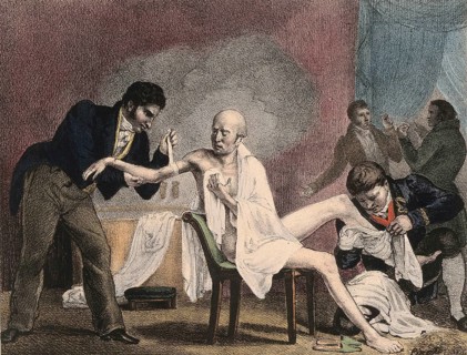 An emaciated old man being treated by four doctors