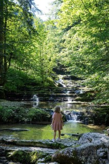 Girl on the bank of the Taugl at the Wald Wasser Zauber Weg near Hintersee