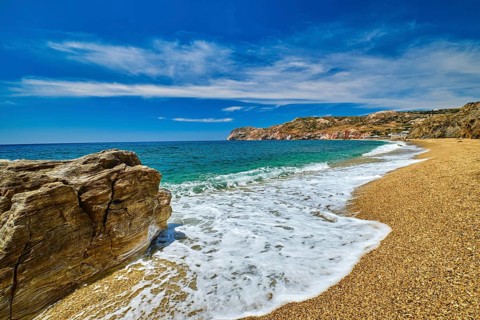 Sunny summer day on pebble and sandy beach Paleochori beach