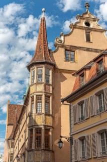 Turret of an old building in a city centre. Colmar