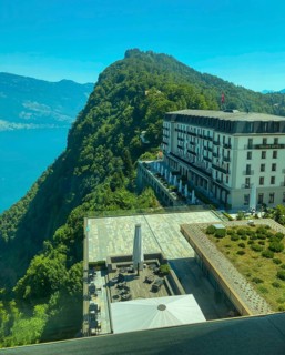 Panoramic Window View over Hotel Palace and Lake Lucerne and Mountain in a Sunny Summer Day in Burgenstock