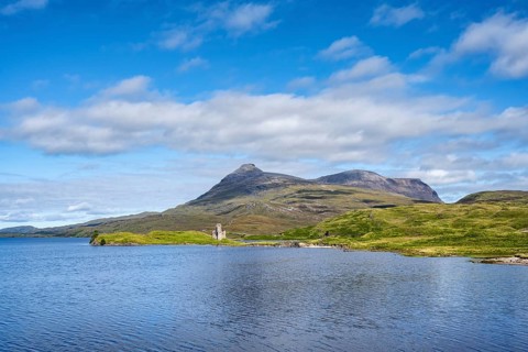 The ruins of Ardvreck Castle on a peninsula by the loch of Loch Assynt