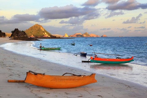 Beach with boats and hills