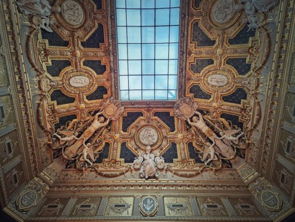 Golden ceiling with architectural details of the Salon Carre inside Louvre museum