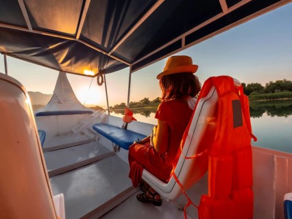 Tourist woman in a boat on a tourist excursion on Lake Shkoder in Shiroka. Albania